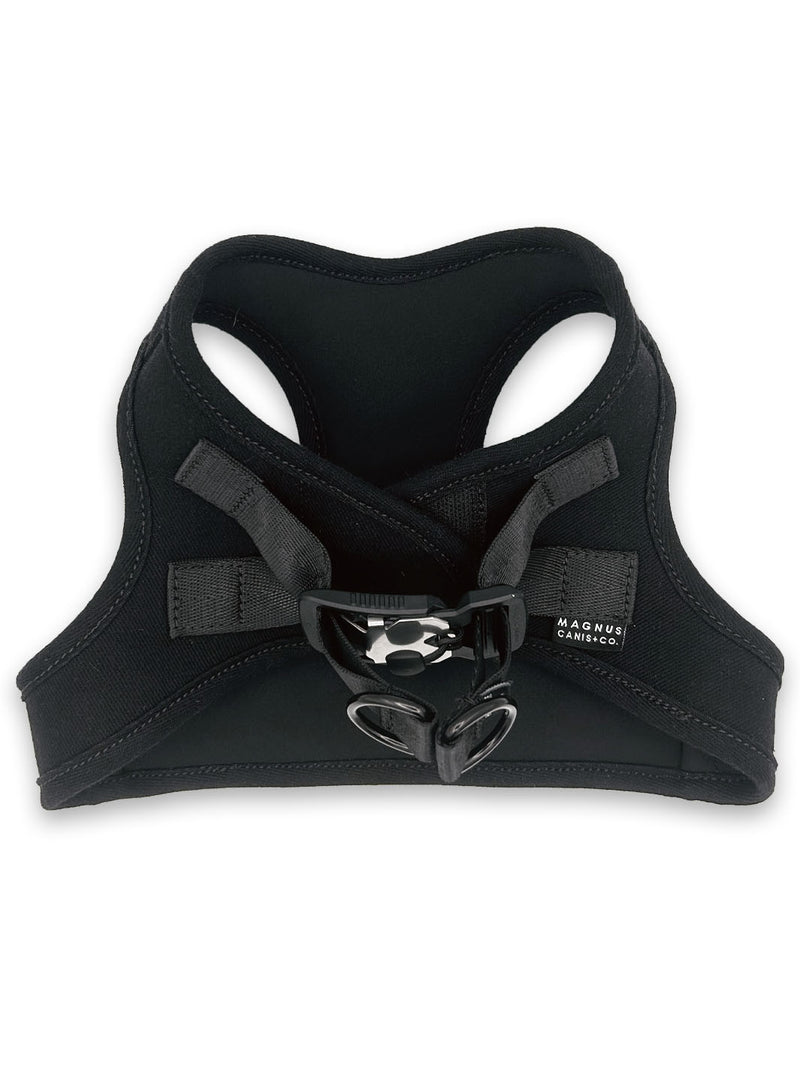 A black made in america denim dog harness laying on a white surface.