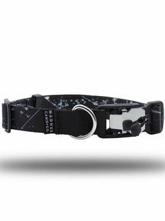 A black and white pattern printed strap dog collar with a magnetic buckle laying horizontally by MAGNUS Canis.