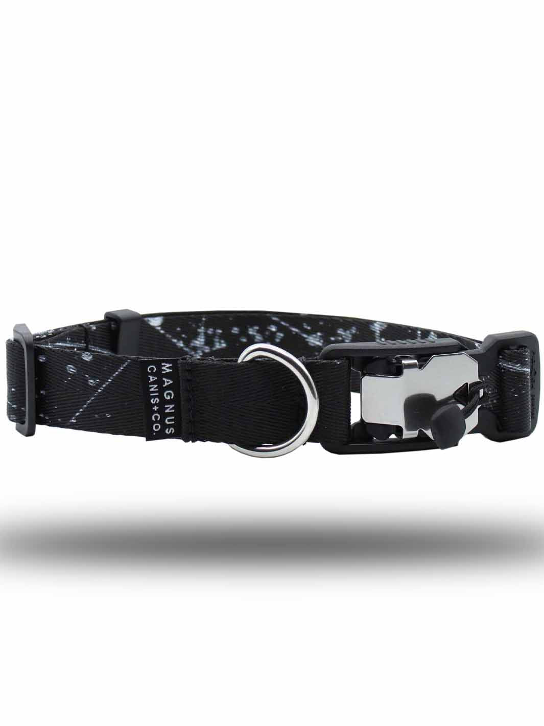 A black and white pattern printed strap dog collar with a magnetic buckle laying horizontally by MAGNUS Canis.