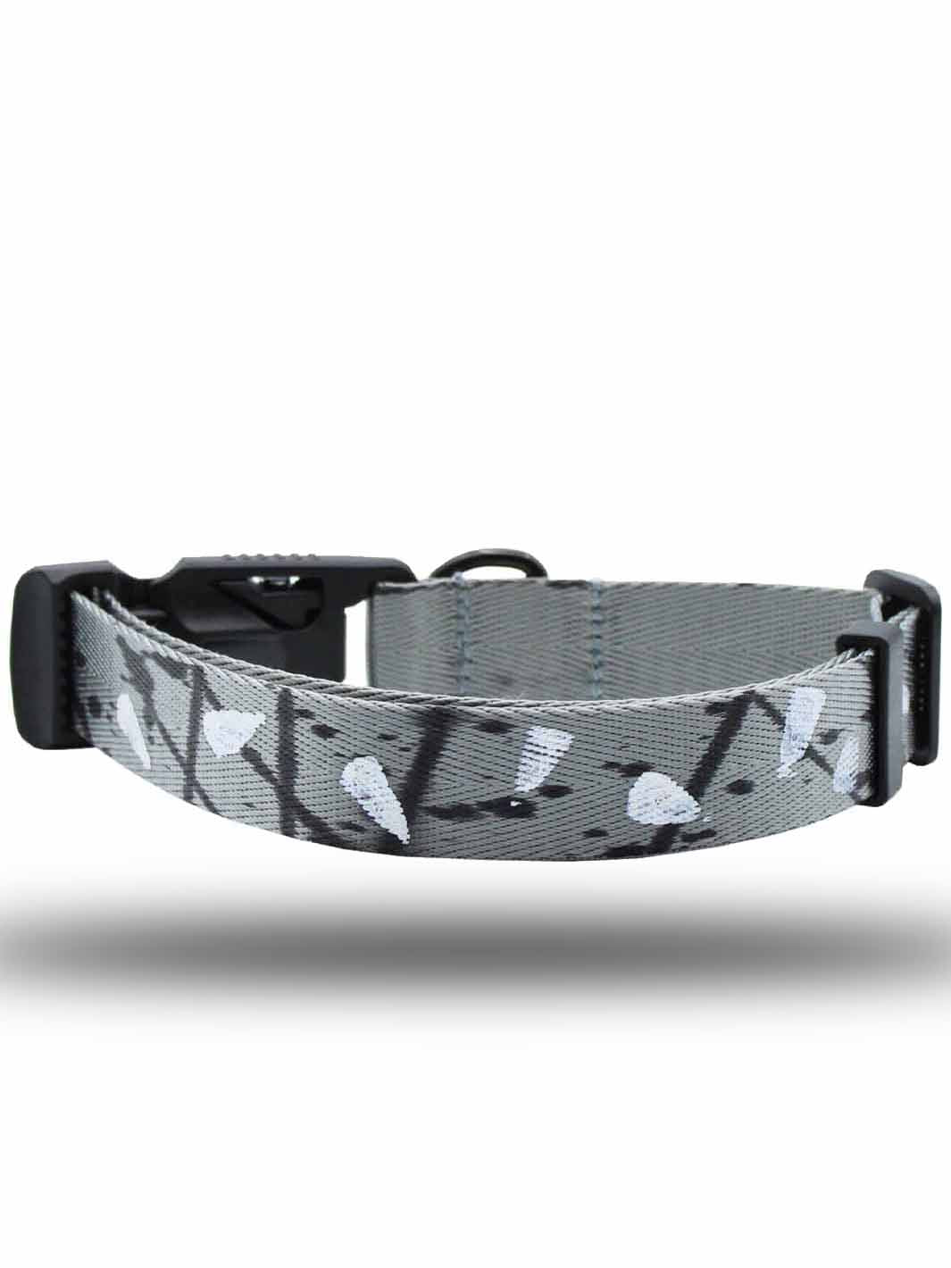 The reverse side of a MAGNUS Canis silver printed pattern strap dog collar with a magnetic buckle laying horizontally.